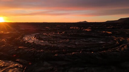 Wall Mural - Textured hardened lava field glowing in warm golden hour light desolate, textured hardened lava, detail