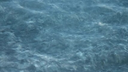 Wall Mural - slow motion close-up of intricate water patterns formed by a gentle ocean current detail, slow motio