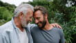 © Helga - Old man with gray beard and his grown son sharing joyful moment during a walk in nature, hugging and laughing, concept of family support, trust, and happiness across generations. o