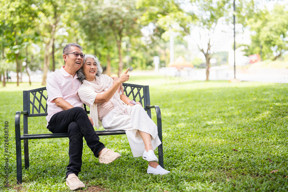 Elderly couple resting on a bench in the park. Stock Photo | Adobe Stock