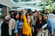 © Jacob Lund - Happy colleagues taking a group selfie in a modern office