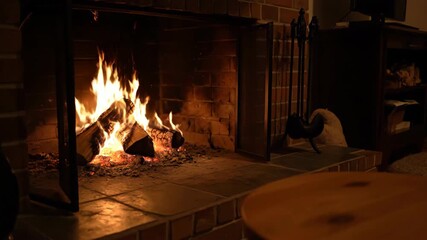 Sticker - a crackling fireplace brings warmth and light to a cozy, dimly lit room, creating a peaceful atmosph