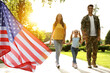 © New Africa - Military man walking with his family outdoors, double exposure with national flag of USA