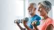 © Valeriia - Senior exercising. Excited senior multiracial man and woman exercising together workout with light dumbbells in both hands.