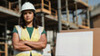 © MEO - Confident hispanic construction woman crossing arms with blank protest sign.