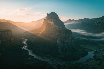 Wall Mural - sunrise drone shot of a waterfall cascading down a mountain