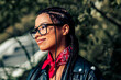 © deagreez - Lovely woman with braided hair and scarf, enjoying day outdoors in urban setting, expressing casual lifestyle and charm