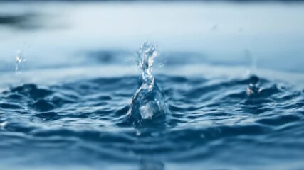 Wall Mural - powerful slow motion water splash with clear, crystalline droplets exploding upwards, filmed with a 