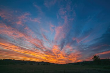 Wall Mural - enjoy a breathtaking autumn sunset scene highlighted by a vivid blue sky and striking clouds to hono