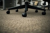 Detailed view of caster wheels on a carpeted surface