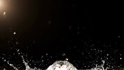 Wall Mural - ethereal slow motion water splash with sparkling droplets caught in a ray of soft backlighting on a 