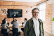 © Maskot - Portrait of smiling senior business expert wearing eyeglasses at office
