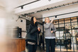 © Maskot - Low angle view of businesswoman showing office interior to newly joined female recruit