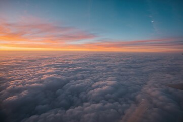 Wall Mural - soaring high over the clouds with a blurred airplane perspective