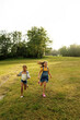 © Maskot - Carefree girls running on playground during rain at camp