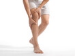 © Prostock-studio - Unrecognizable millennial european man suffer from pain in knee and touching to leg, isolated on white background, copy space. Trauma, chronic arthritis and sports injury and health care, studio shot