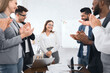 © Prostock-studio - Business team congratulating successful female manager with applause at conference meeting