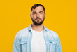 © Prostock-studio - Serious calm mature european man with beard in casual look at camera, isolated on yellow background, copy space. Man ignoring someone, feeling stressed and unhappy. Facial expression and poker face