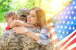 © New Africa - Military man and his family outdoors, double exposure with national flag of USA