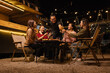 © SOMKID - Happy Friends Celebrating Together at Night, Young Asian Group of Friends Having Fun and Toasting Drinks Outdoors, Enjoying a Celebration Concept.