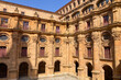 Salamanca University with its historic facade and ornate Plateresque architecture under a bright sky in Salamanca, Spain