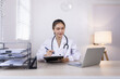 © SOMKID - Medical professional using a computer for online patient support, Medical professional and Healthcare technology Concept.