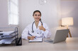 © SOMKID - Medical professional using a computer for online patient support, Medical professional and Healthcare technology Concept.