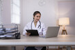 © SOMKID - Medical professional using a computer for online patient support, Medical professional and Healthcare technology Concept.