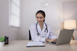 © SOMKID - Medical professional using a computer for online patient support, Medical professional and Healthcare technology Concept.