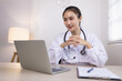 © SOMKID - Medical professional using a computer for online patient support, Medical professional and Healthcare technology Concept.
