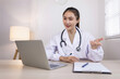 © SOMKID - Medical professional using a computer for online patient support, Medical professional and Healthcare technology Concept.