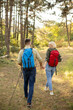 © BGStock72 - Couple enjoying a hike together in a lush forest setting during a sunny afternoon