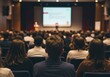 © Ozz - Audience members attentively listen to a presentation in a large conference hall.