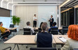 © chadchai - Business presentation in modern conference room showcasing data analysis and strategic planning with engaged audience participation