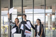 © Ron - A group of business workers from different generations celebrate great deal by throwing papers to the sky in an office. Moment of happiness among coworkers after solving business challenges.