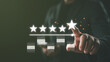 © Looker_Studio - Hand giving five star rating on virtual interface, symbolizing excellent customer satisfaction, online review system, feedback evaluation, and business reputation management.