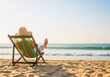 © InfinityVisuals - Beach Chair Serenity: A sun-kissed individual lounges in a vibrant beach chair, absorbing the tranquility of the ocean on a flawless summer day, embodying the spirit of relaxation and freedom.