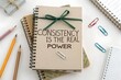 © YLing - Stacked notebooks tied with a green ribbon showing a motivational quote