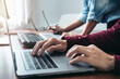 © Freedomz - Asian man programmer looking code data on laptop to brainstorming with partner about new project