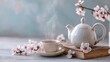 © saputri - A tranquil scene of a steaming cup of tea and a teapot, surrounded by delicate spring blossoms, evokes a sense of peace and serenity.