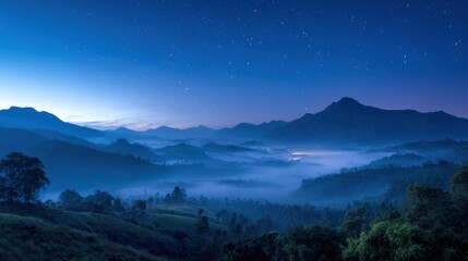 Wall Mural - A breathtaking twilight scene captures mist rolling over lush valleys. Stars dot the clear sky as distant mountains rise majestically. The peaceful atmosphere invites reflection on nature.