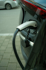 Electric vehicle charging station with white cable in Scandinavian setting, clarity and sustainable green energy mobility background for branding and editorial layouts