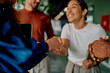 © we.bond.creations - Diverse business partners are shaking hands at an office meeting, symbolizing agreement, partnership, and successful collaboration