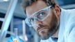 © Анастасия Онацкая - Portrait of a scientist in a futuristic laboratory, wearing safety glasses and lab coat, carefully analyzing a glowing test tube under cinematic blue lighting.