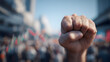 © sornram - A raised fist symbolizes unity and strength during a peaceful protest for social change.