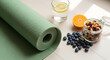 © ManuStockStudio - Healthy Lifestyle Concept With Yoga Mat Fruits Nuts And Water