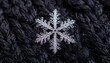 © Yahut - Detailed close-up of a delicate snowflake on dark fabric