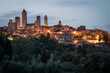 Historical city of San Giminiano with all its towers illuminated on a summer evening. Province of Siena, Tuscany, Italy