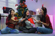 © crizzystudio - Asian friends celebrating christmas playing guitar singing carols