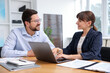 © New Africa - Consultant working with client at table in office. Business meeting